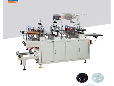 Plastic lid forming machine