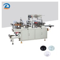 Plastic lid forming machine